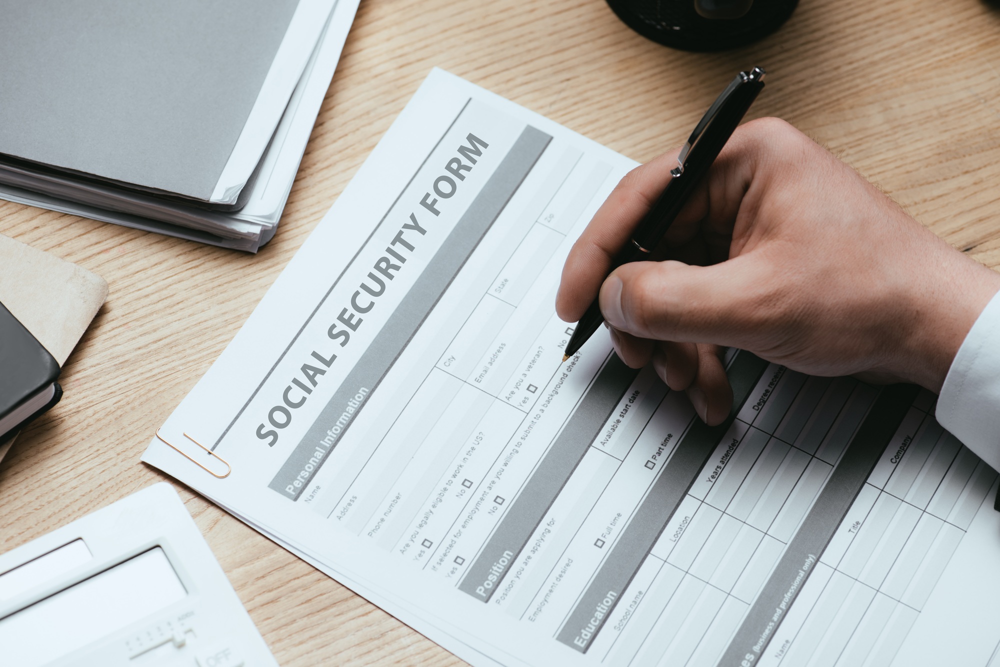 cropped view of man filling in Social Security Form Concept